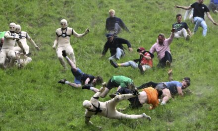 AP PHOTOS: Runners trip, stumble and roll their way to victory in annual downhill cheese chase