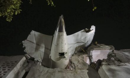 AP PHOTO: Air India plane’s tail juts from a building